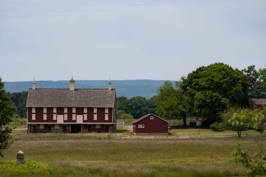 Get a view of old barns and buildings like this red and cream colored one from the top of the overlooks on the Gettysburg battlefields.