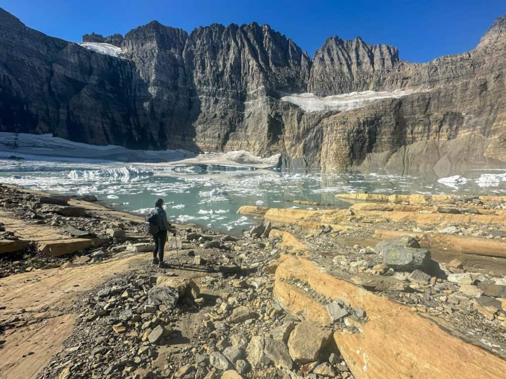 Sam observes ice still floating in the lake next to Grinnell Glacier on a sunny day in September.