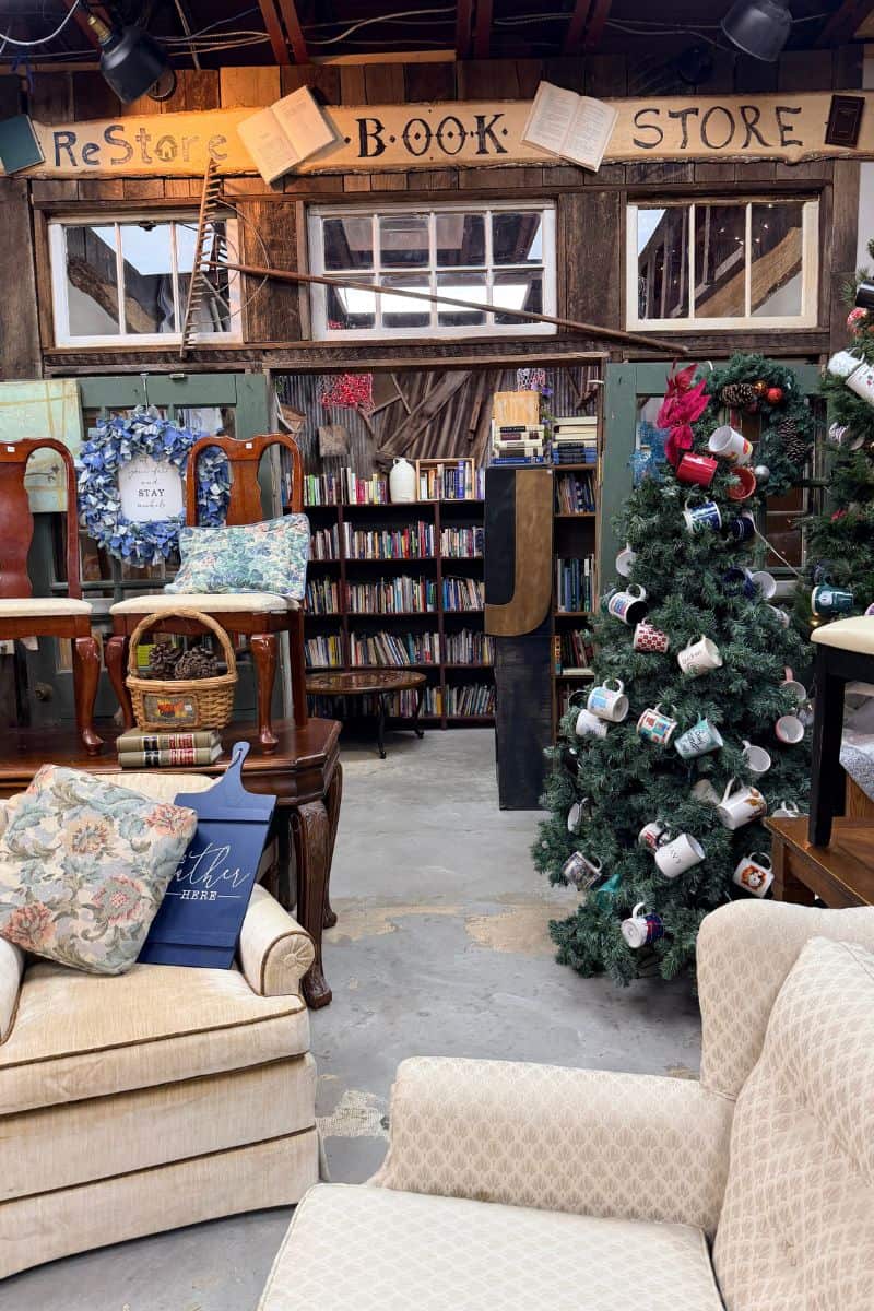 Secondhand furniture, books, and a Christmas tree decorated with mugs inside the ReStore Book Store in Teays Valley, West Virginia.