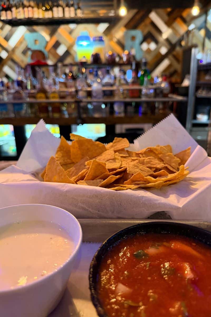A basket of tortilla chips served with queso and salsa at Whiskey Taco in Hurricane, West Virginia.